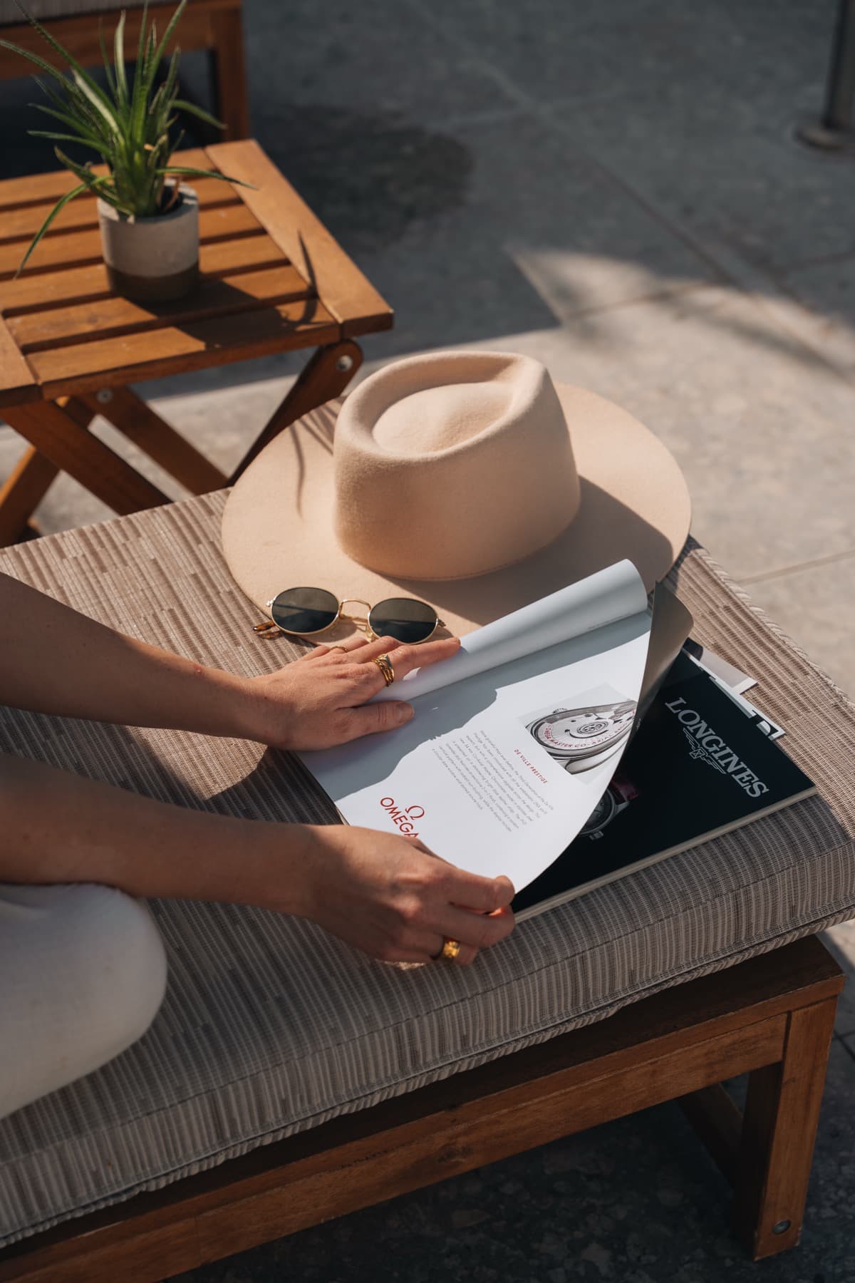 Reading a magazine outdoors on a sunny terrace