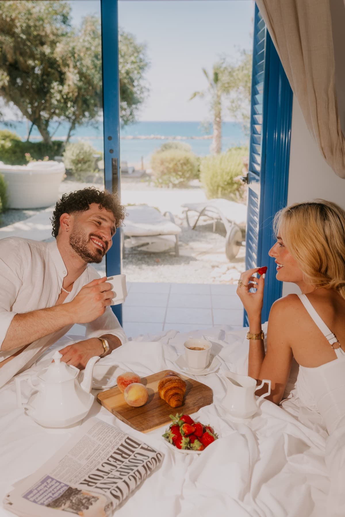 Couple enjoying breakfast with a sea view at a Nomads Properties villa