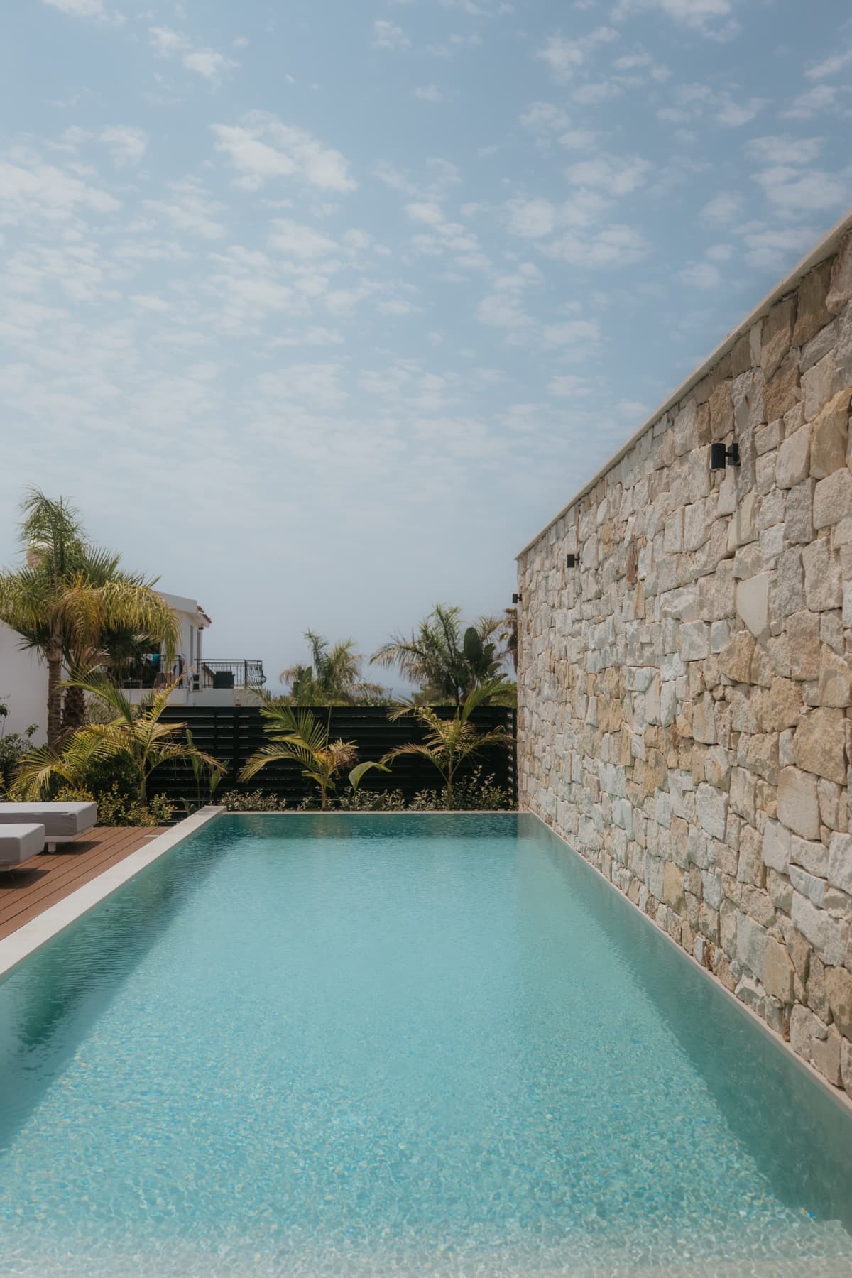 Infinity pool with stone feature wall at a managed villa